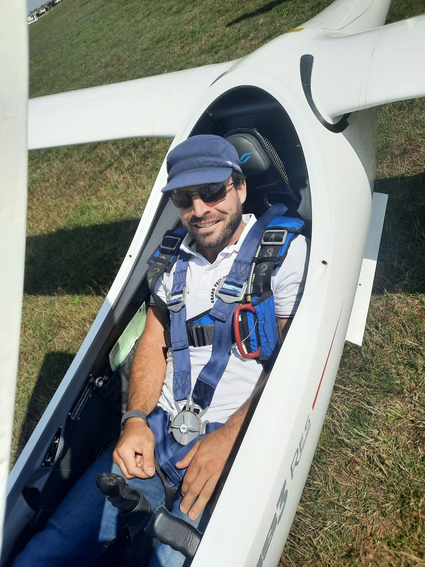 Yves Gerster in the cockpit of his glider on the ground, harness on