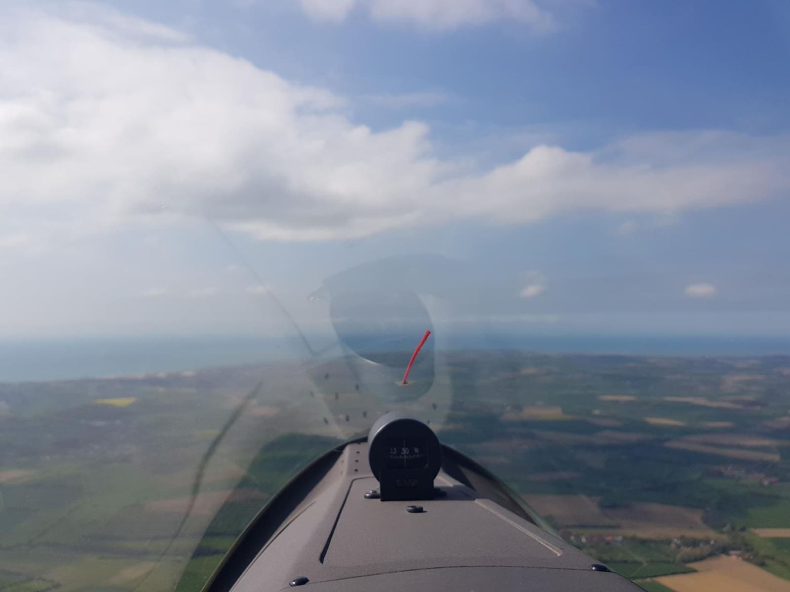 Green English countryside under the glider after crossing the Channel